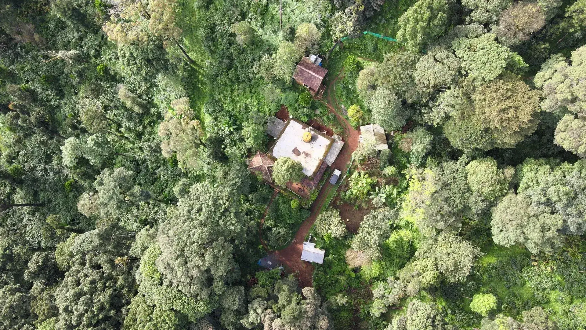 Aerial view of the Mount Wood property tucked into the misty Coorg hills